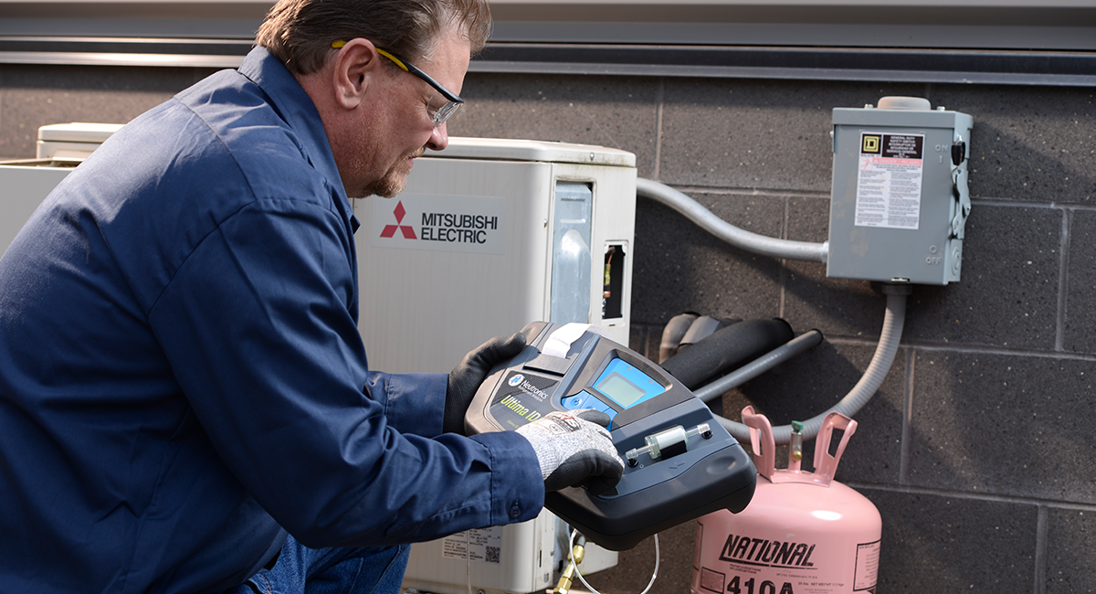 Technician servicing an HVAC system using R-410A refrigerant