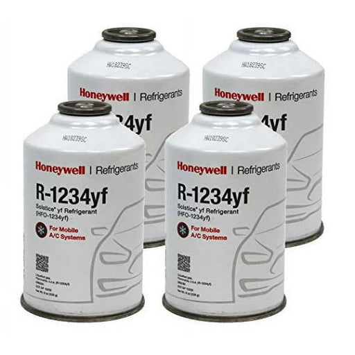 Four cans of Honeywell R-1234yf refrigerant, used as a 134a replacement for vehicle air conditioning.